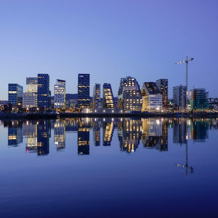 cityscape by water during golden hour