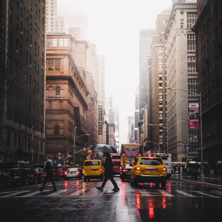 person walking on pedestrian lane between buildings